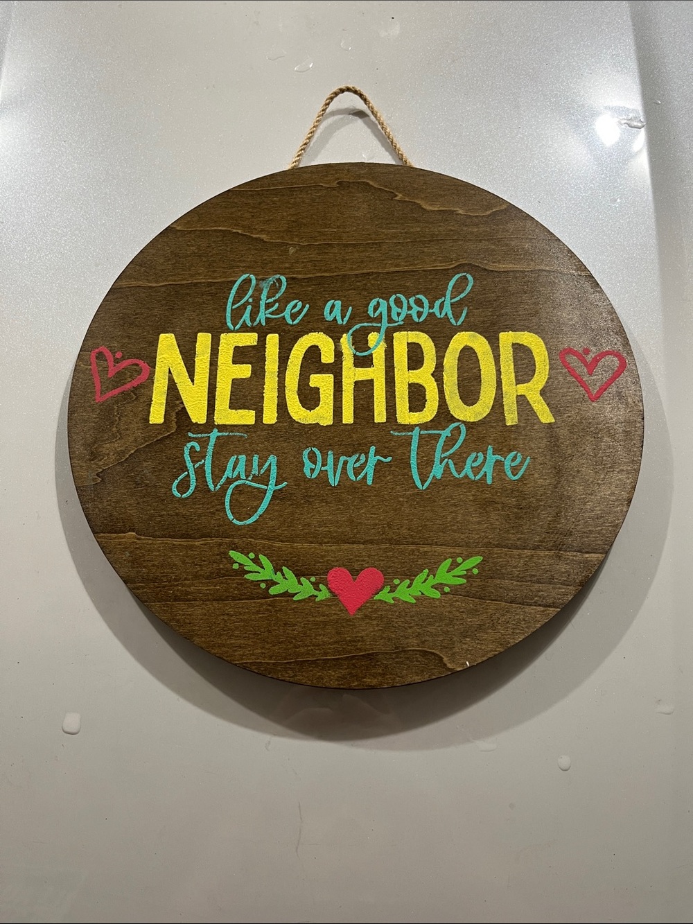 Wooden Round Wall Sign "Like a Good Neighbor" - Yellow, Teal, Red Accents
